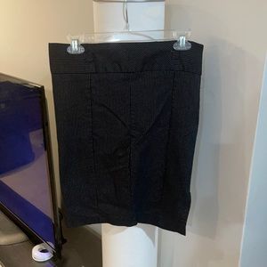 Black pin stripe mini skirt with a slit in the back.